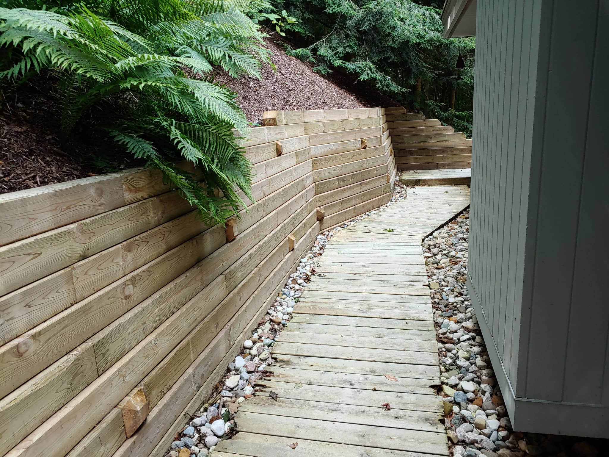 Custom Wood Walkway - Hardscaping project by Aesthetic Gardener Holland MI
